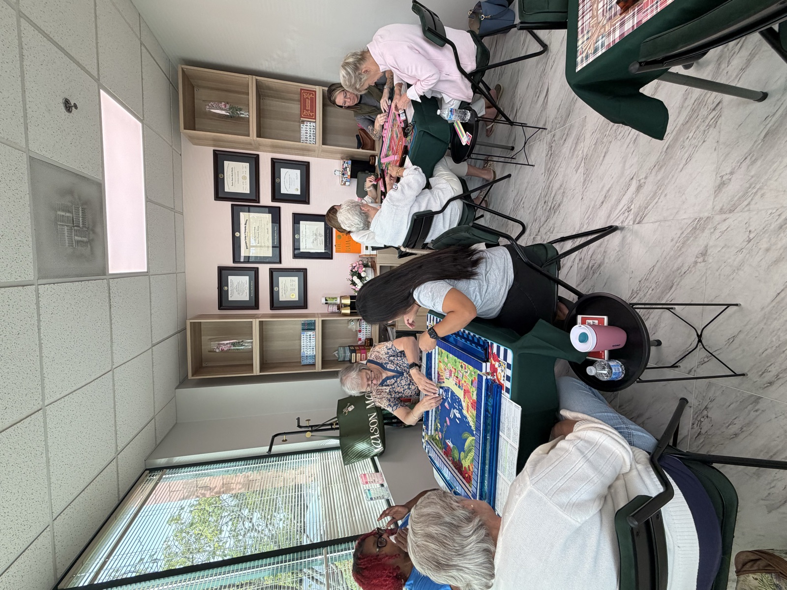 Players seated at three tables during an Open Play session at Unique Health Now